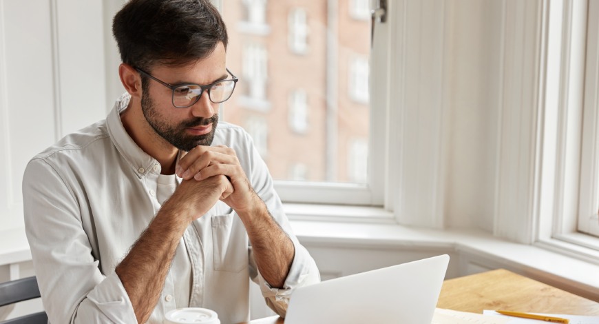 man on laptop using approval software