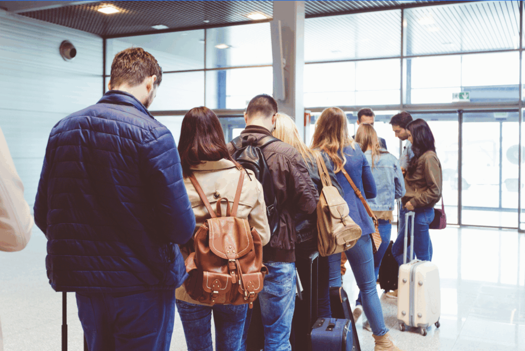 people in a line waiting for their flight after a cyber attack. Waiting for their instant alerts